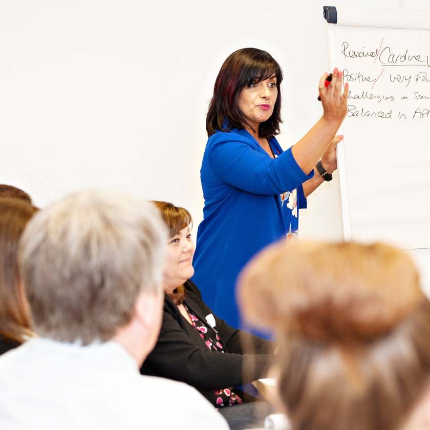 Woman presenting in front of seated audience