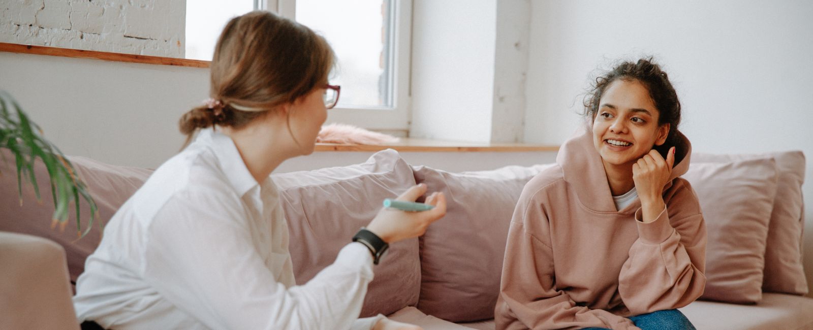 Two women sitting on couch in therapy session