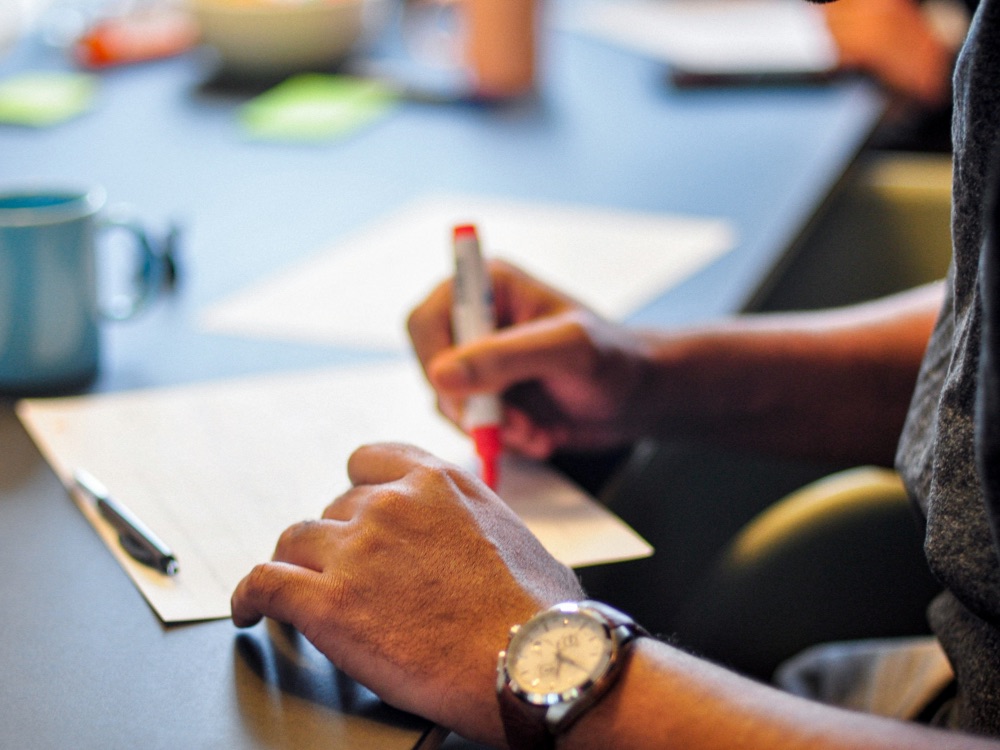 Close up of male hands writing on paper