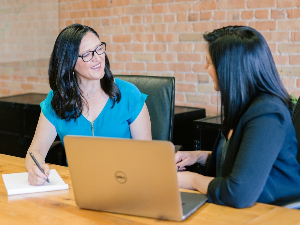 Two professional women in an interview scenario
